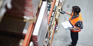 Warehouse worker scanning inventory in a pick zone