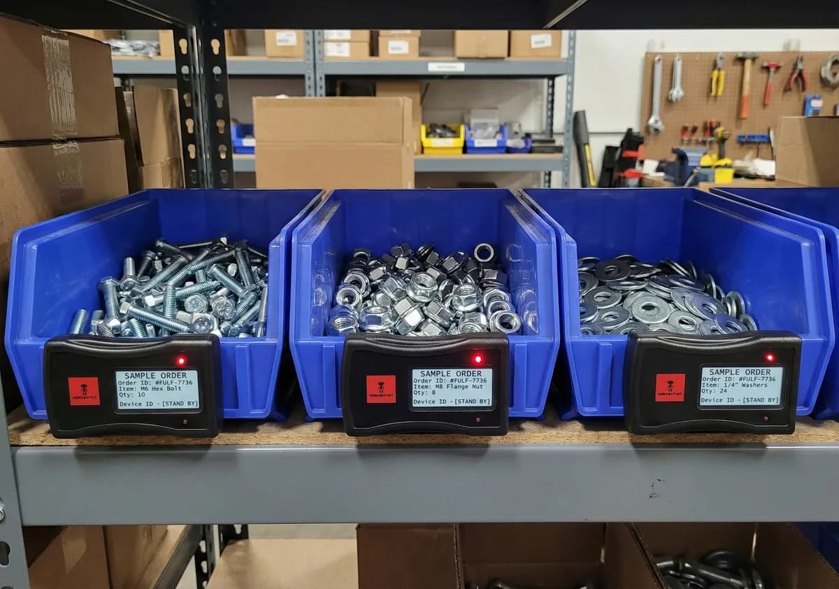 Hero Bot devices mounted on blue bins for small parts picking